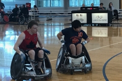 Zion' racing to cut off another athlete in Wheelchair Rubgy.