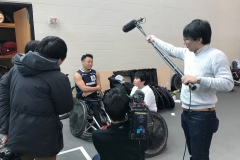 One of many interviews. Zion interviewed for Japanese TV during a wheelchair rugby tournament. Pictured with EK, a member of the Japanese national team training in the US.