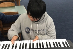 Zion learning piano with only two fingers.